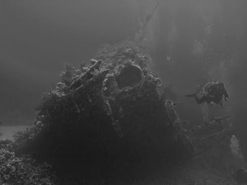 Free Diver near Shipwreck on Seabed Stock Photo