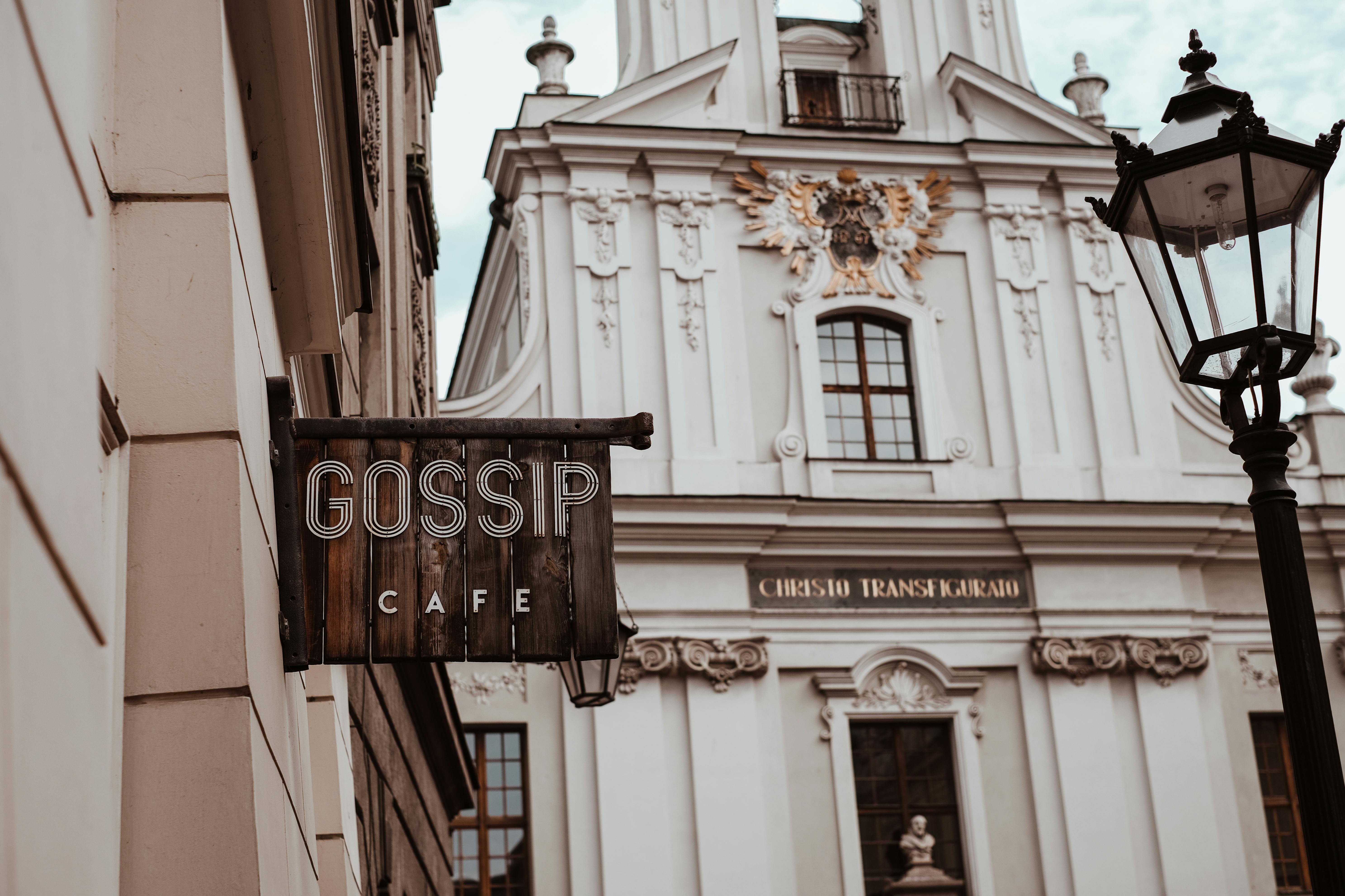 Church of the Transfiguration in Kraków with a café sign and classic architecture.