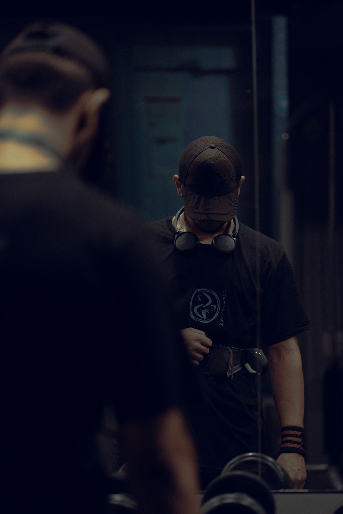 Athlete with headphones in a dark gym