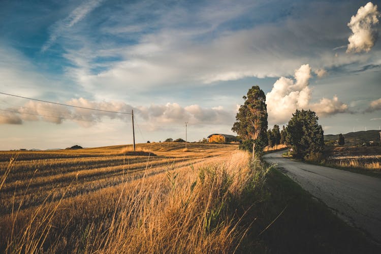 Clouds Over Field And Road In Countryside