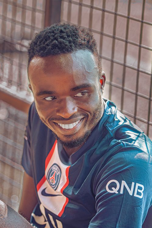 Free Portrait of a smiling man in a soccer jersey with sunlight. Stock Photo
