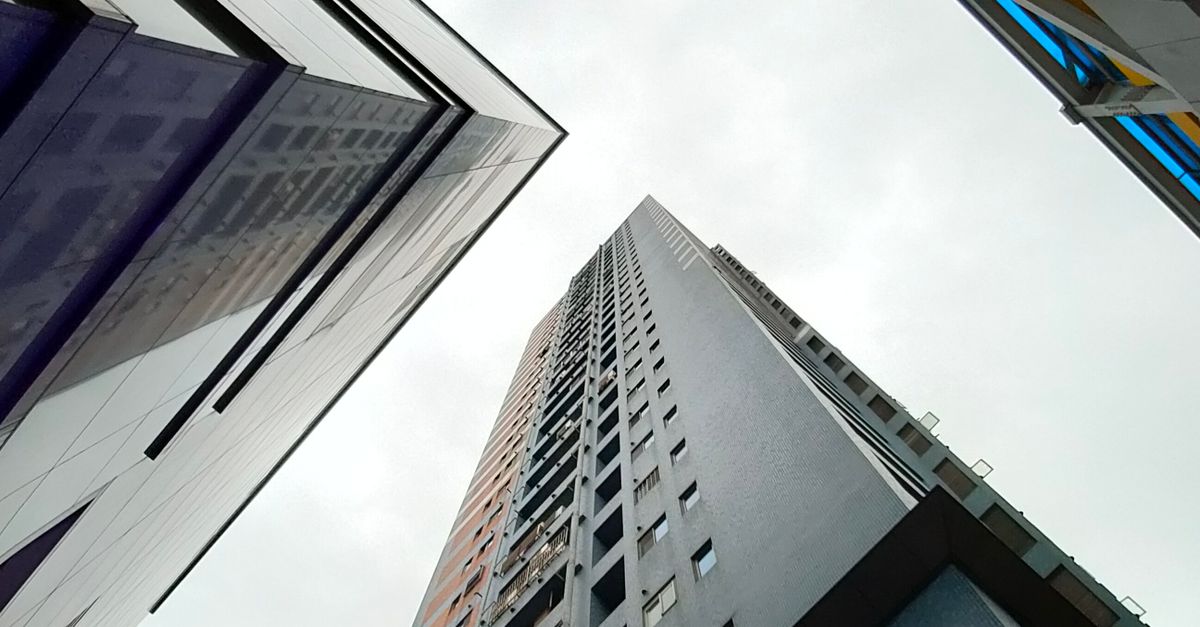 High Rise And Low Rise Building Low Angle Photography of High Rise Buildings · Free Stock Photo