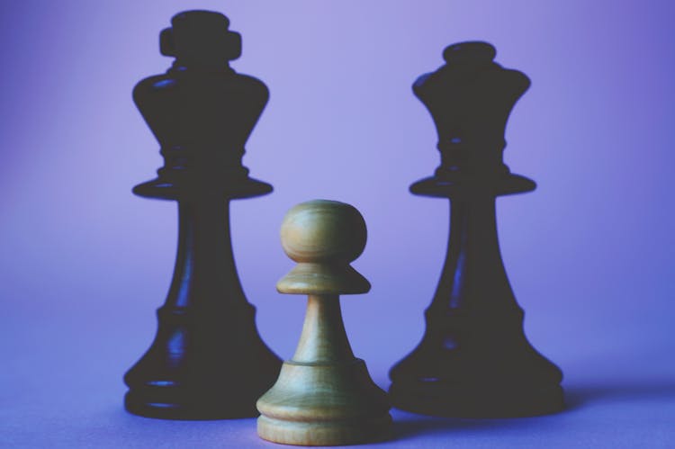 Three Black And Beige Chess Pieces