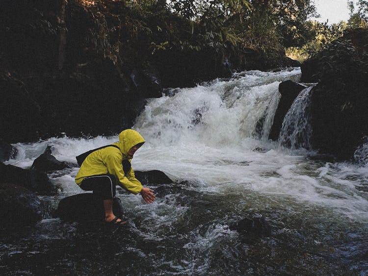 Man Washing Hands In River