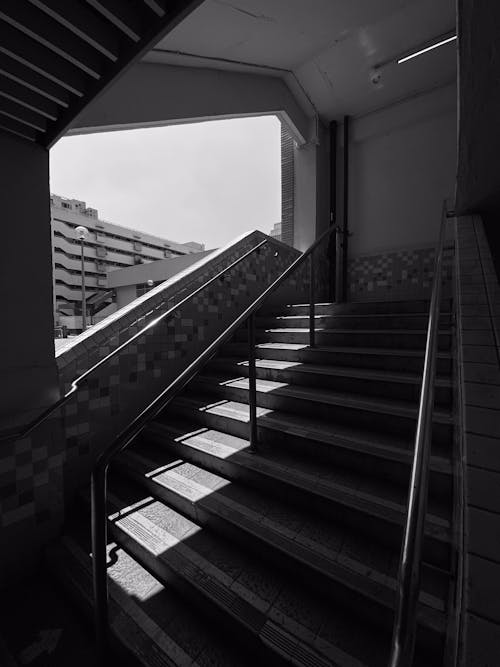 Grayscale Photo of Stairs inside a Building