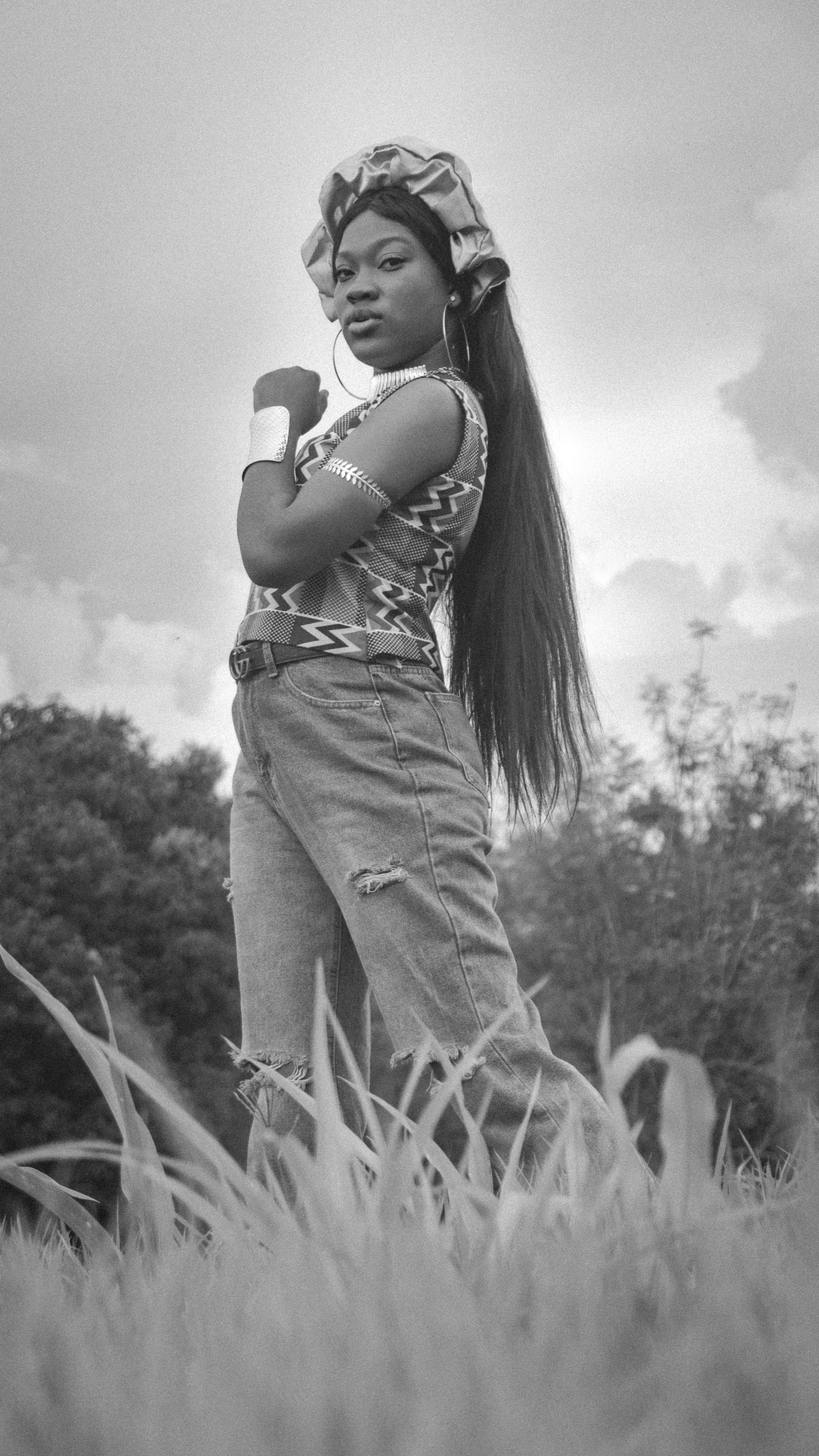 Grayscale Photo of a Woman Standing on a Grass Field · Free Stock Photo