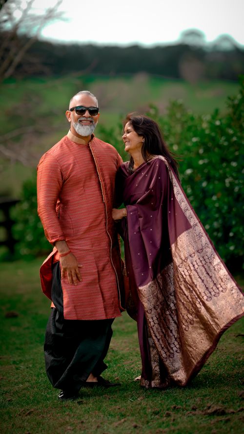 Free Elderly couple enjoying a day outdoors in traditional attire, showcasing love and affection. Stock Photo