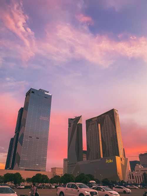 Free Skyscrapers against a vibrant sunset in Phnom Penh's cityscape. Stock Photo