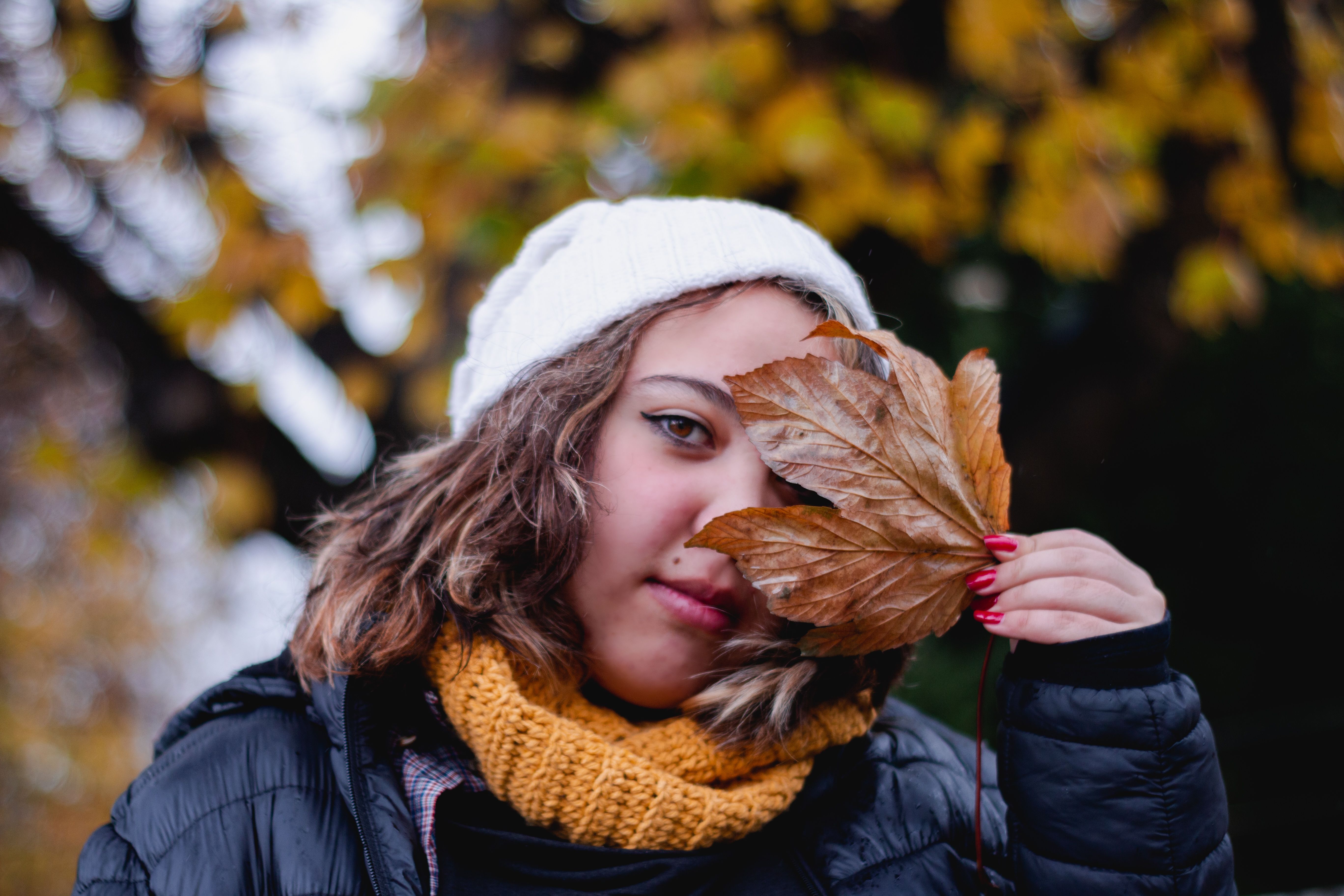 Woman Covering Eye with a Brown Leaf · Free Stock Photo