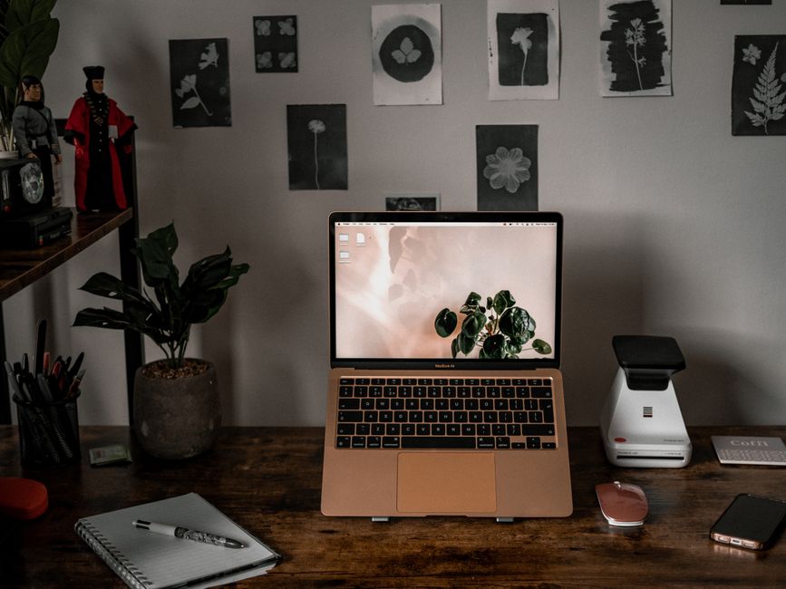 Nanit Pro vs Owlet Dream Sock: Breathing Tracking Accuracy Showdown A stylish desk setup with laptop, plants, and wall art, ideal for remote work and creativity.