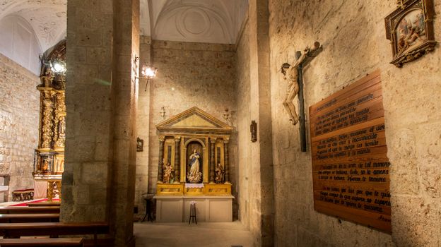 A serene view of a Catholic church interior featuring a crucifix and Virgin Mary altar, evoking spirituality.