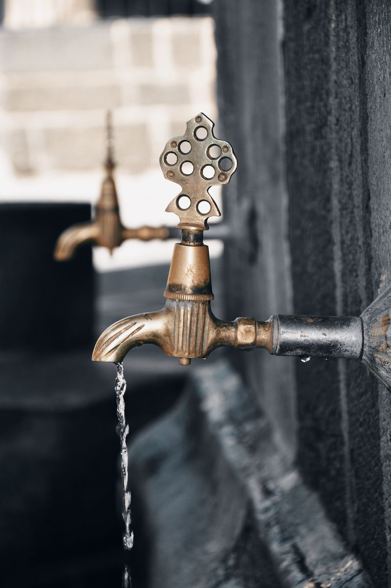 Brass tap dripping water