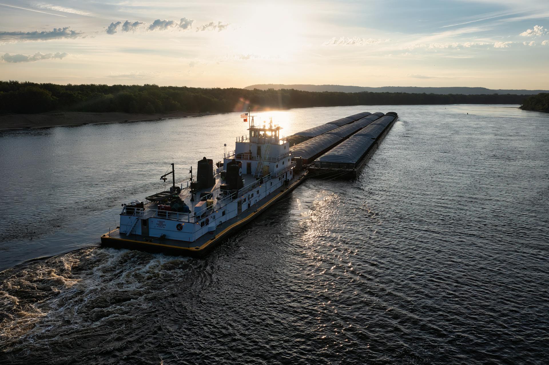 A barge sails along the Mississippi River at sunset in Reads Landing, Minnesota.