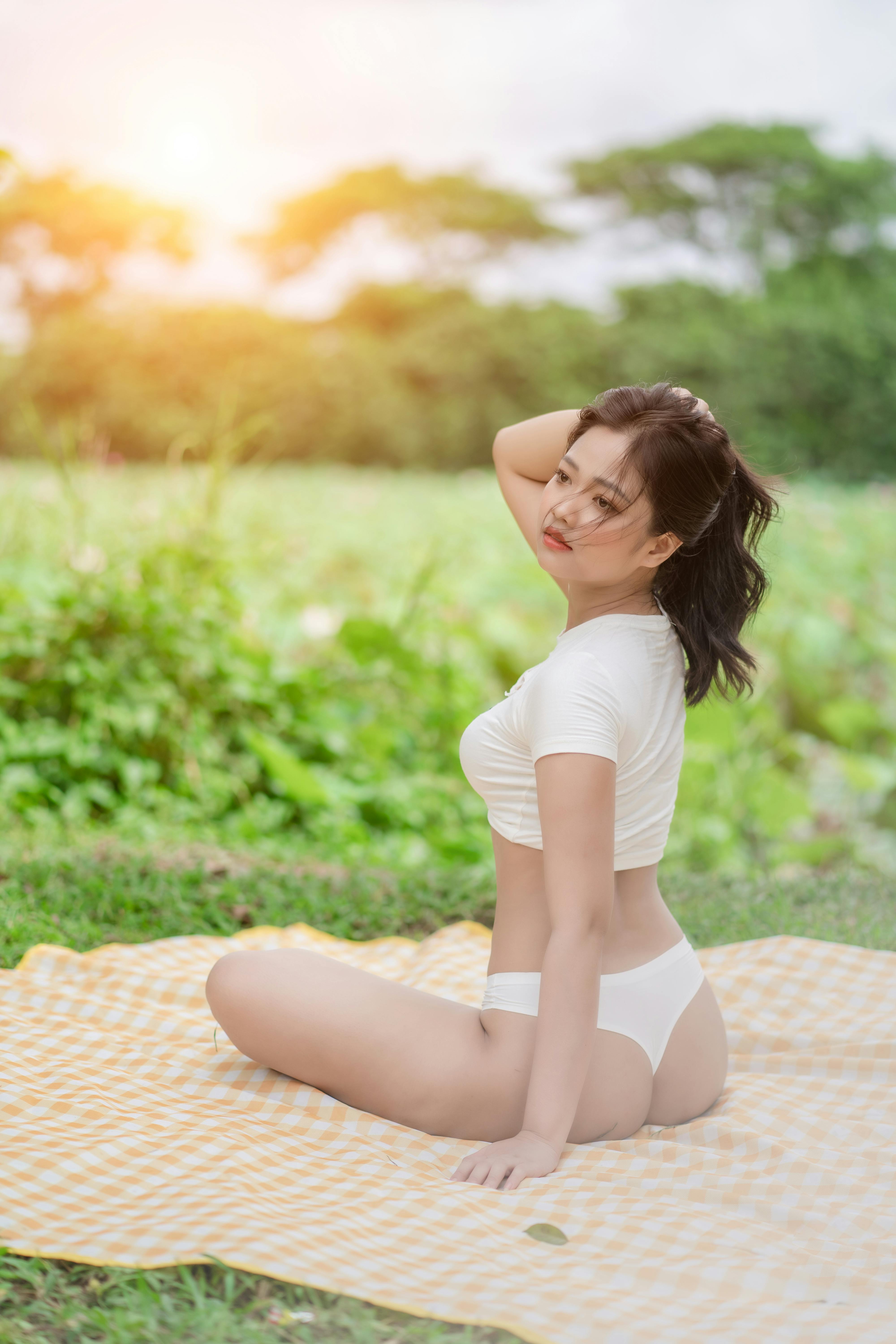 Sexy Woman in White Underwear Sitting on Picnic Blanket · Free Stock Photo