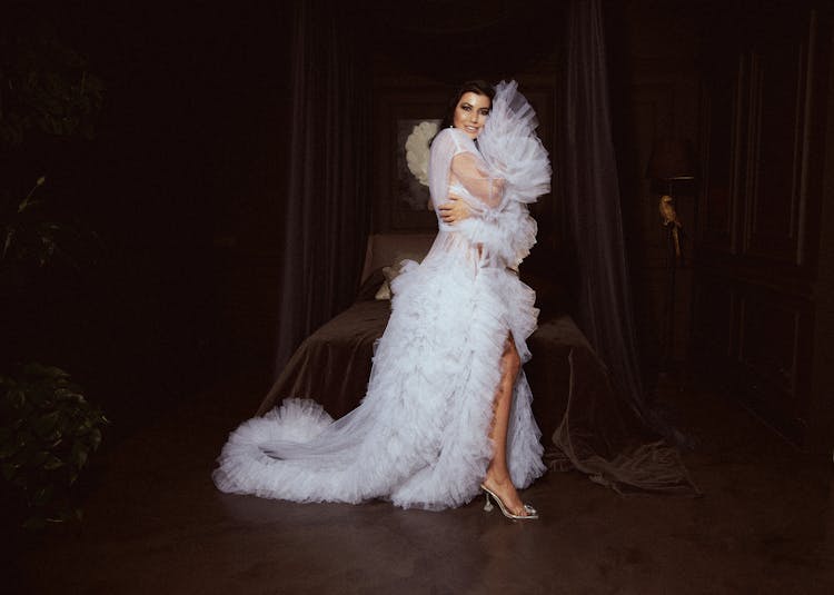 Woman In A Long White Dress With Ruffles