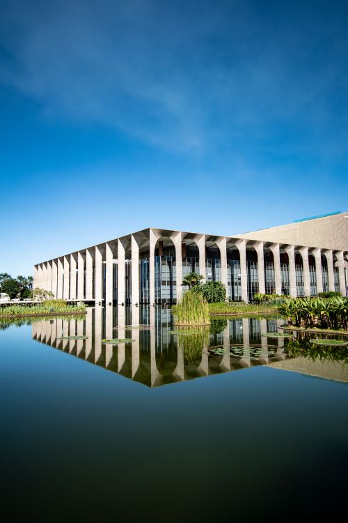Free Elegant view of Palácio Itamaraty, Brasília, reflecting in water under a clear blue sky. Stock Photo
