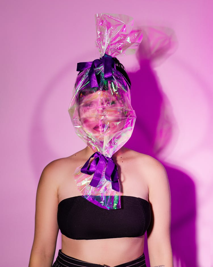 Woman In Creative Makeup Wearing A Plastic Bag In A Shape Of A Candy On Her Head