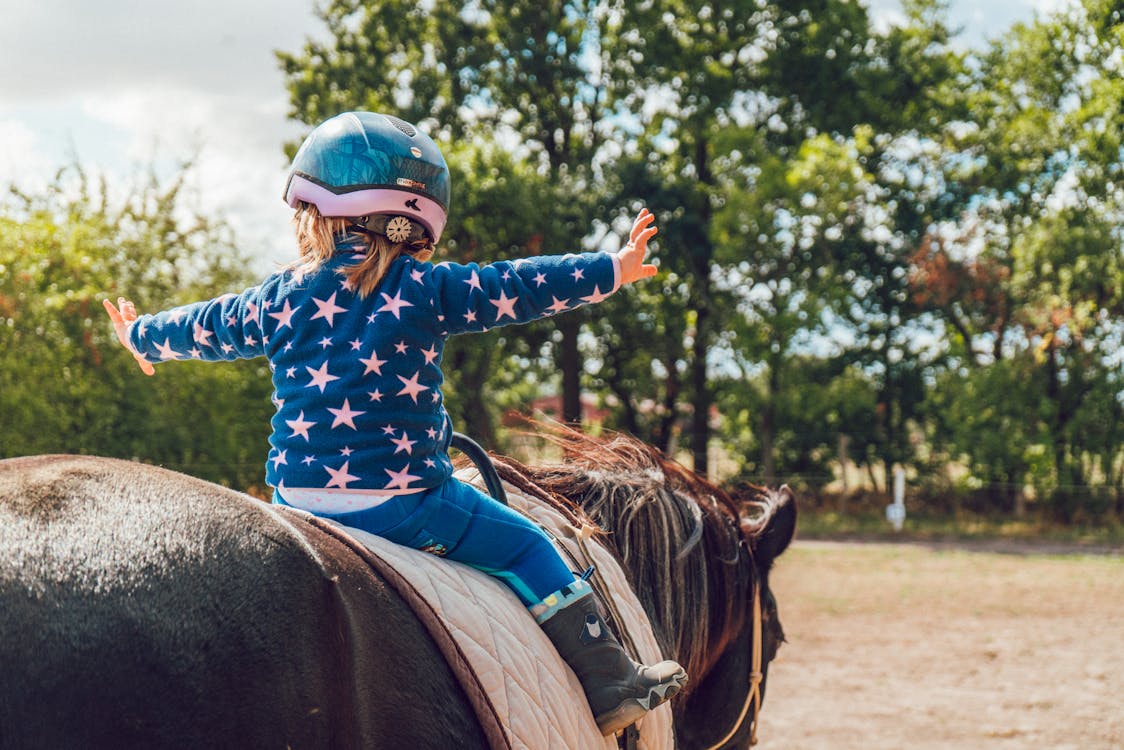 Free Girl Riding Black Horse Stock Photo