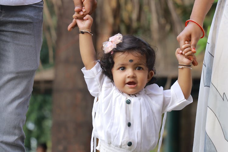 A Toddler In White Dress