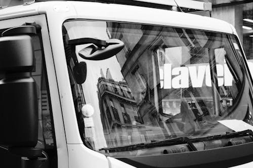 Free Grayscale Photo of a Man Sitting Inside a Truck Stock Photo