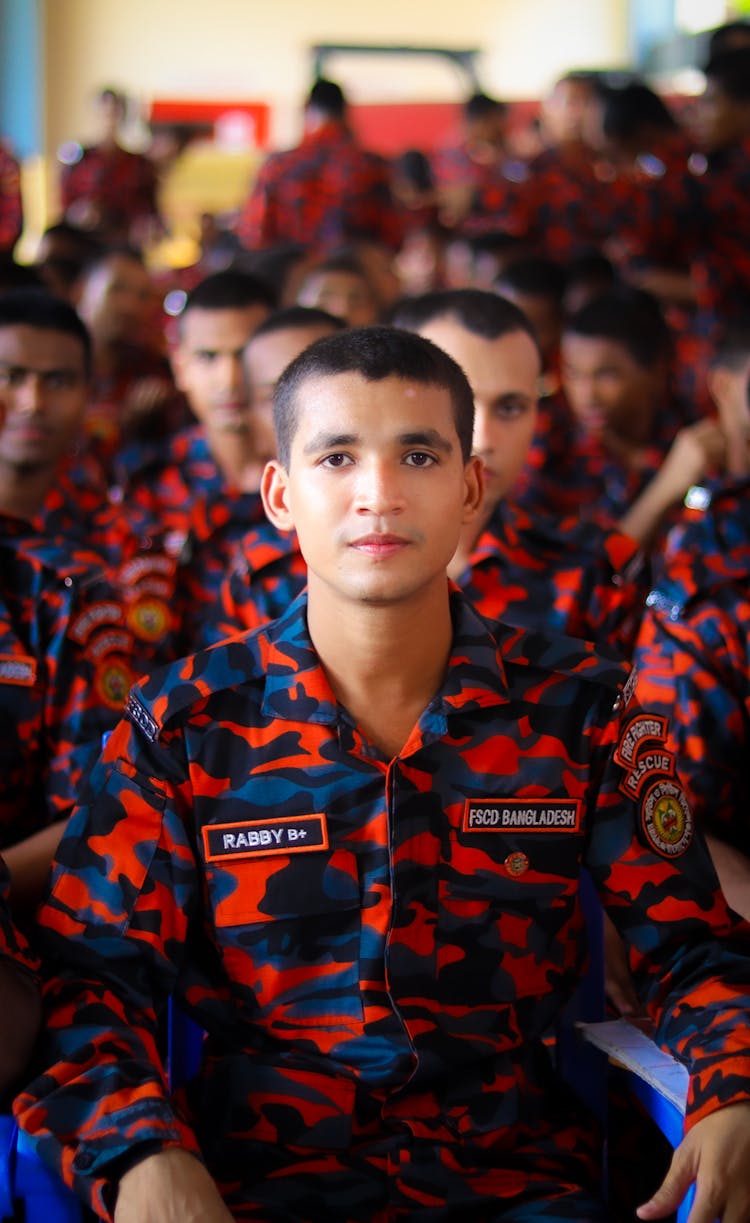 A Man In Orange And Blue Fire Fighter Uniform