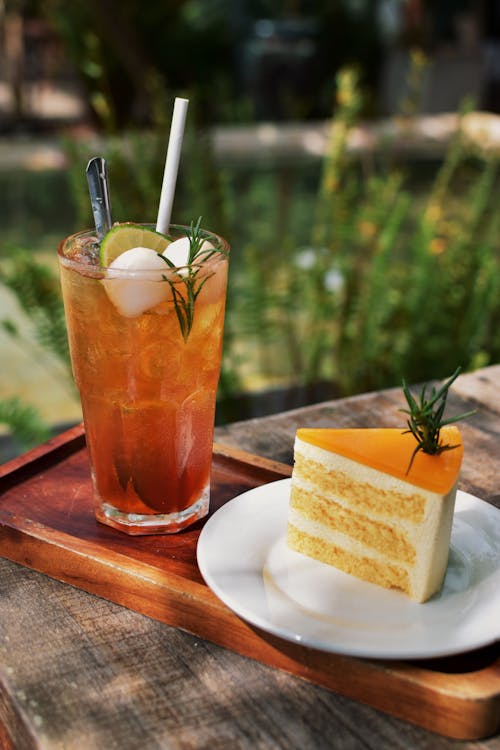 Free Refreshing Cocktail and a Slice of Cake Stock Photo