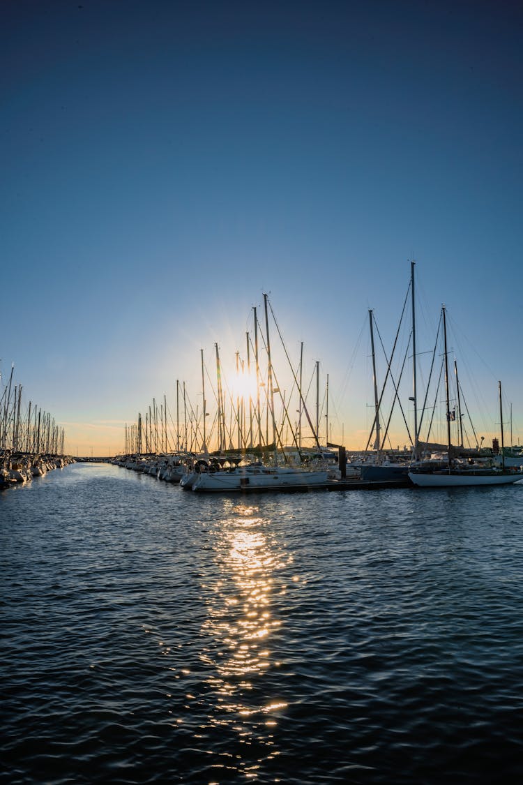 Sailboats Docked On Harbor Under A Bright Sun