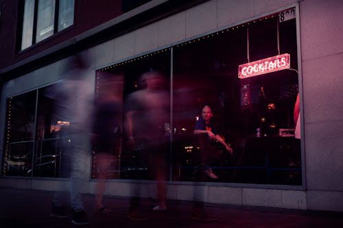 Free Photo of People Walking by a Bar  Stock Photo