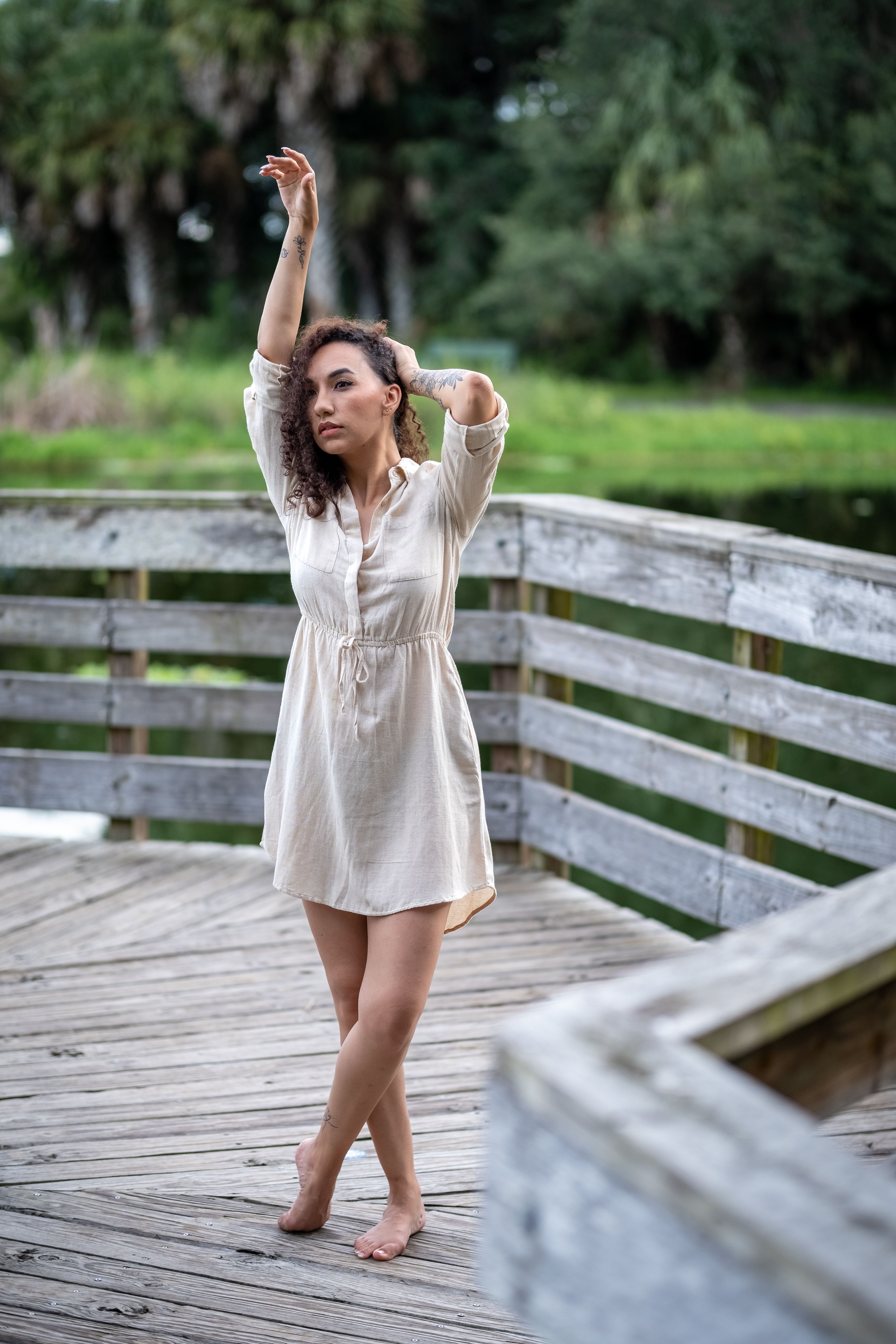 short dress poses Photo Stock Nice tanned stylish brunette girl in red short dress with flowers is standing poses and flirting walking on the street city