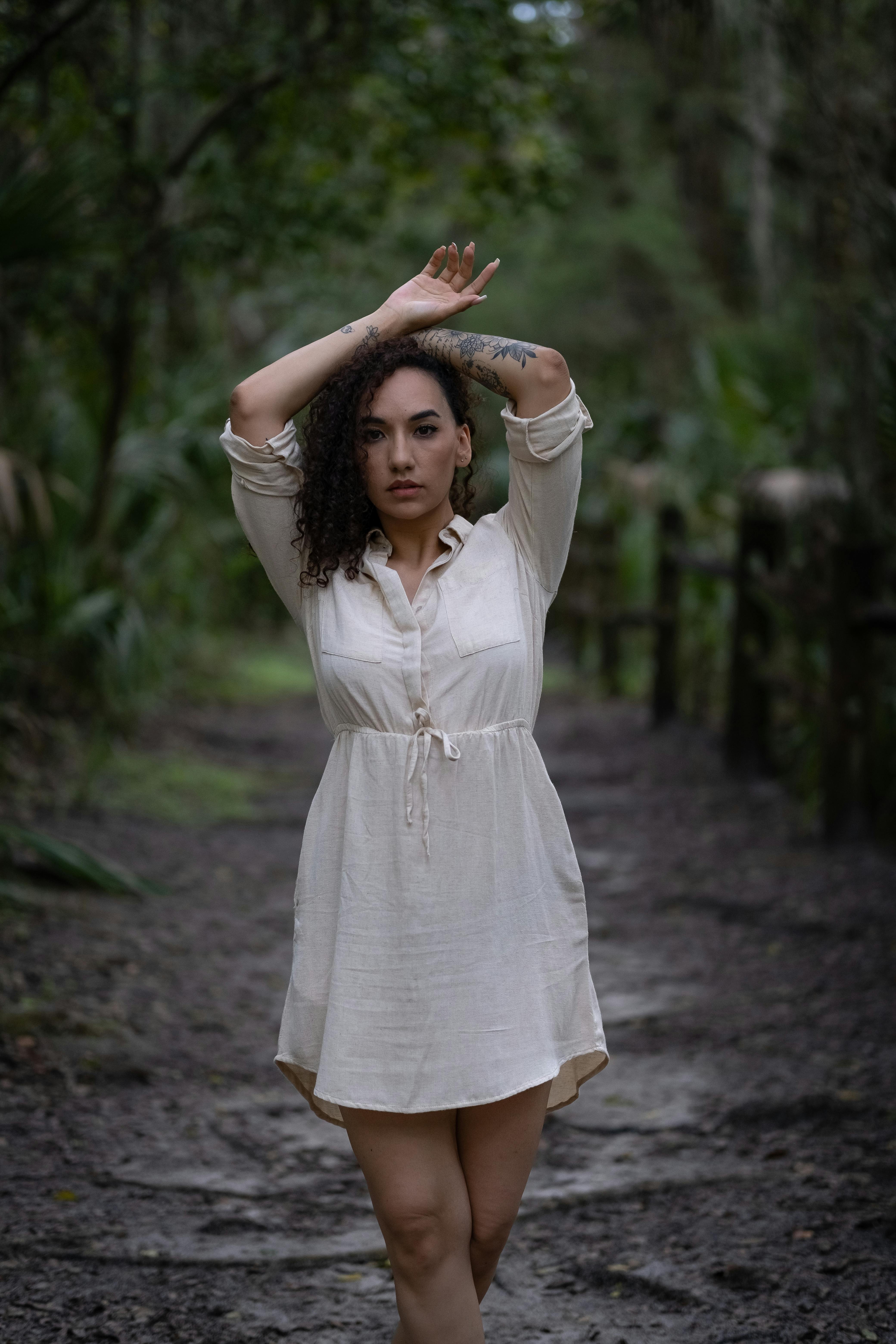 Woman in Beige Dress Standing on Dirt Ground  Free Stock Photo