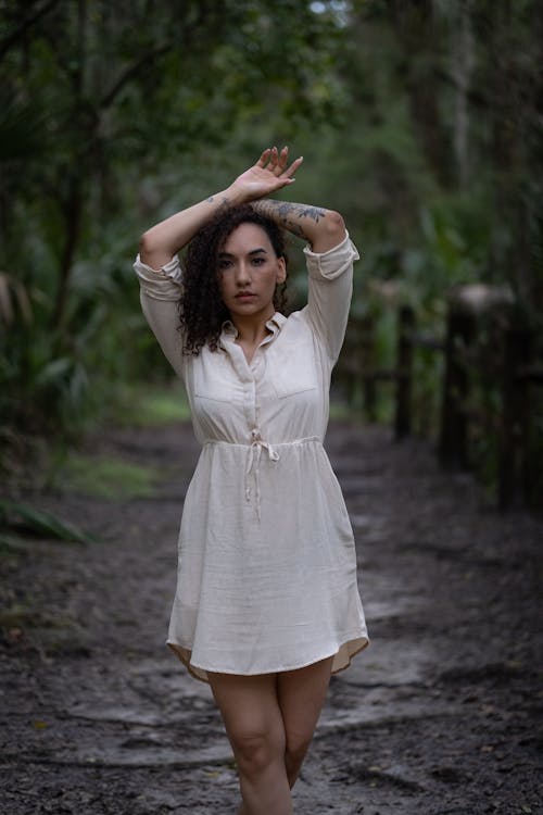 Woman in Beige Dress Standing on Dirt Ground