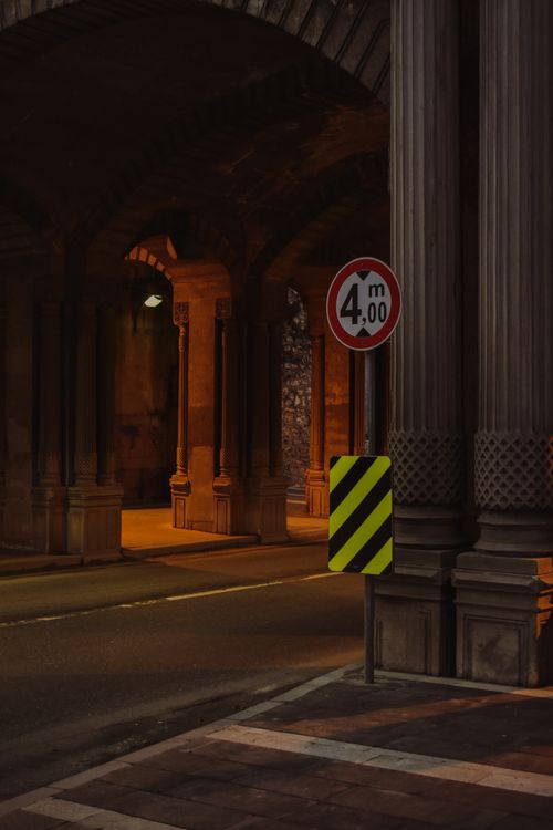 Free Historic stone archway in İstanbul with moody lighting and street sign at night. Stock Photo