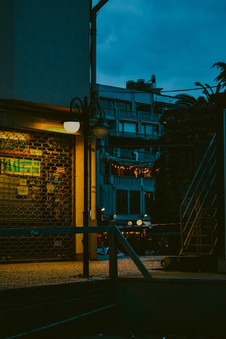 Empty Sidewalk With Lighted Lamp Post 