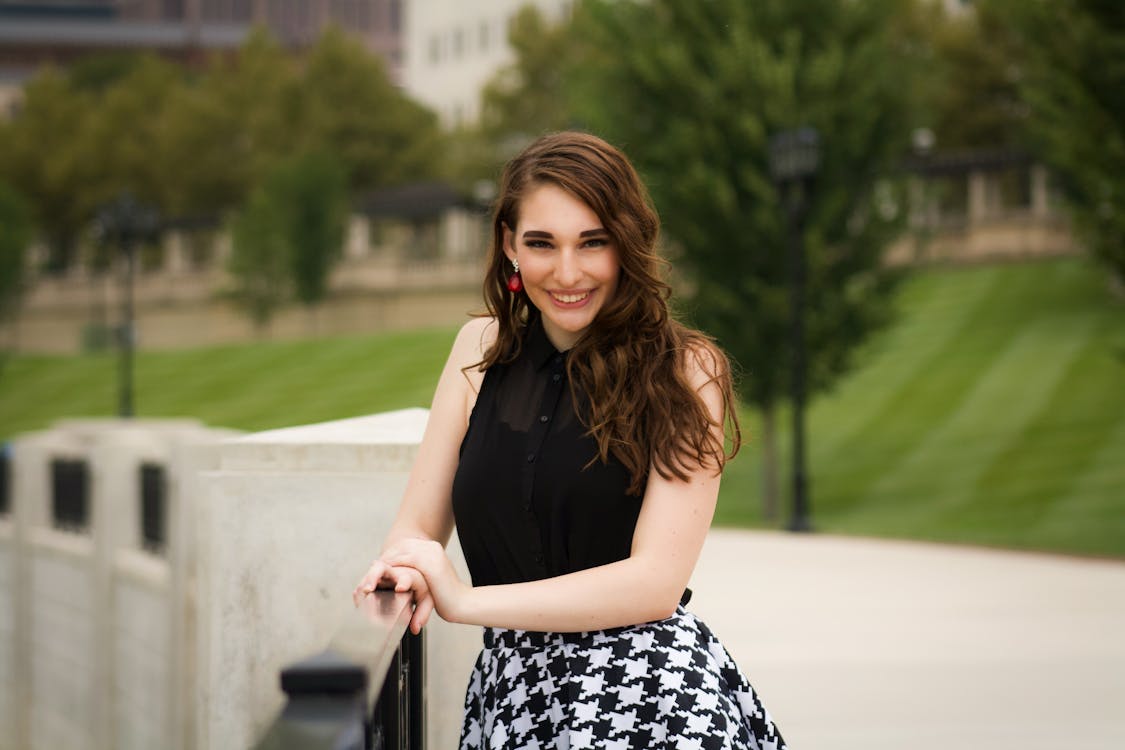 Smiling Woman Wearing Black And White Dress