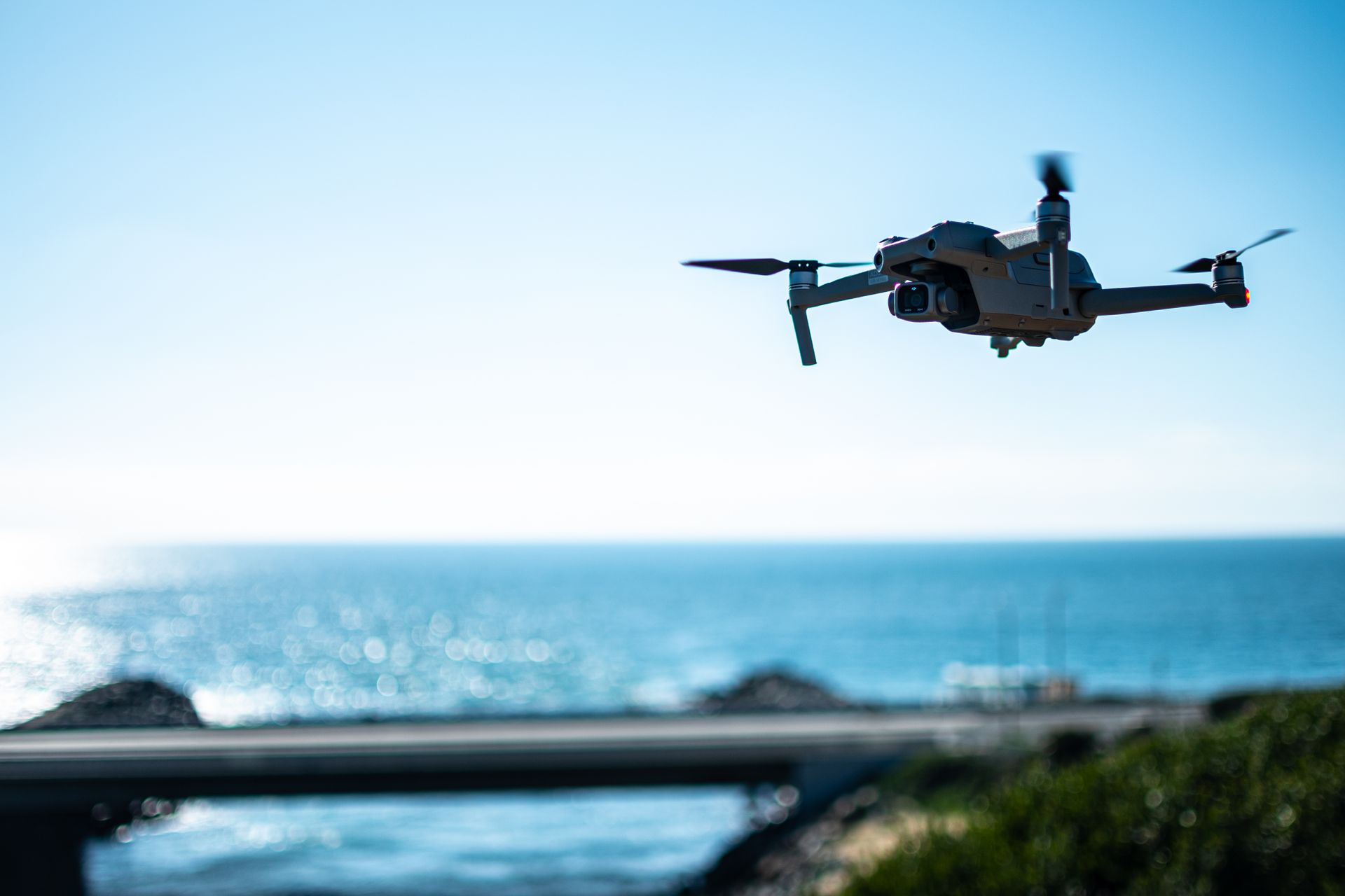 Aerial view of a drone flying over the sea in Carlsbad, California on a sunny day.
