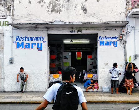 A lively street view outside Restaurante Mary in Mérida, Mexico, capturing local life.