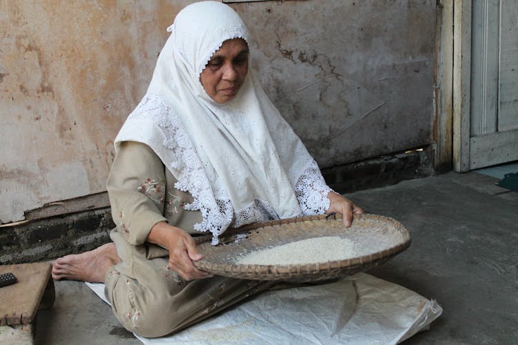 Woman Sitting On Floor With Tray