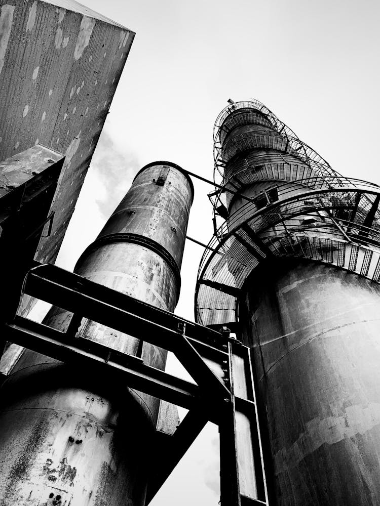 Grayscale Photo Of Smokestacks 