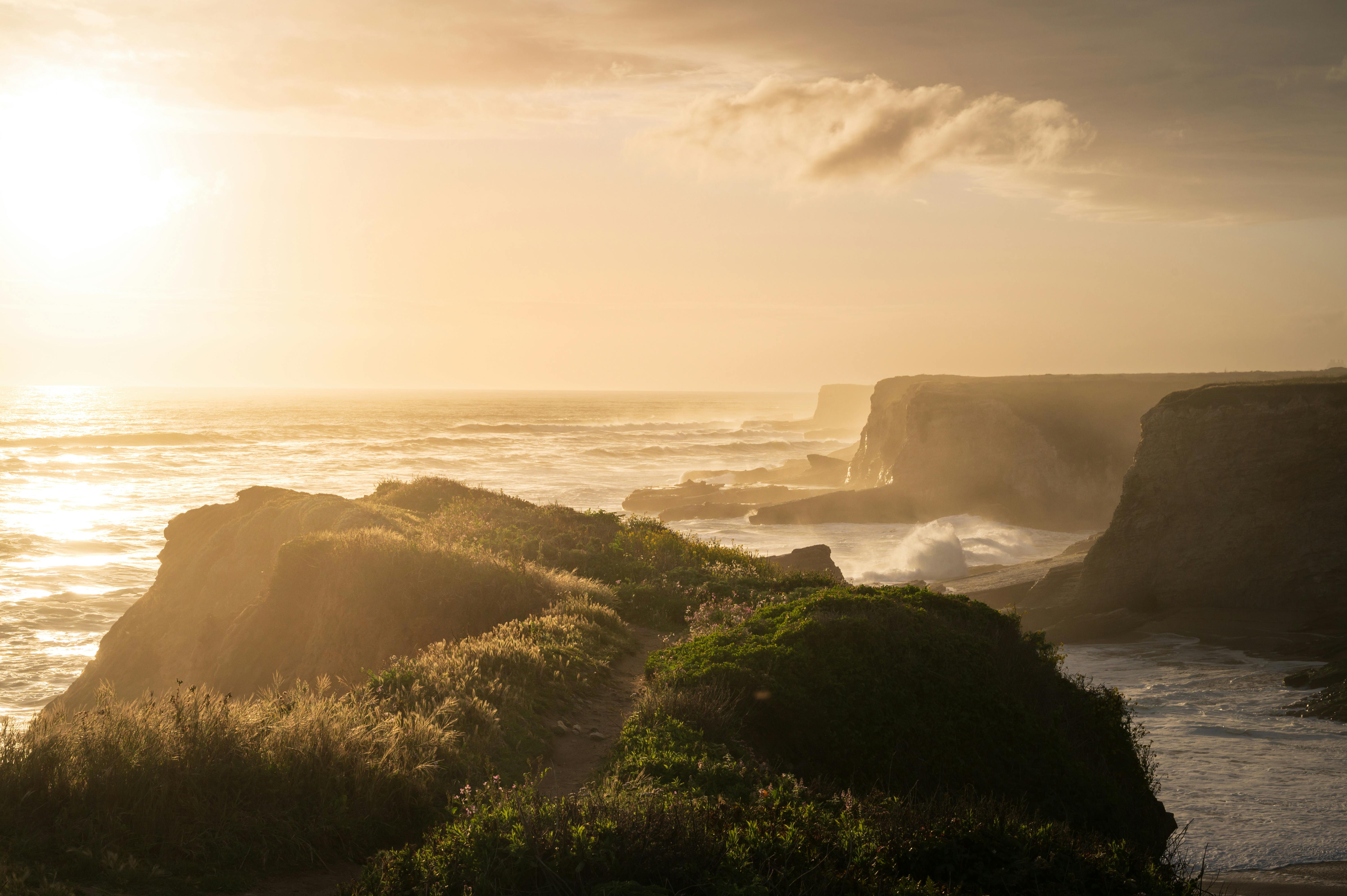 cliff coast on the ocean during sunset