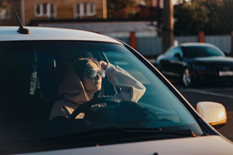 Photograph Of A Woman With Sunglasses Waiting In A Car