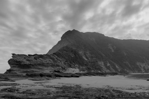 Free Grayscale Photo of Mountain Near Body of Water Stock Photo