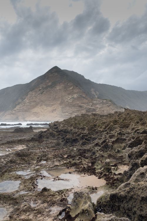 Free Captivating view of a rocky coastal mountain under cloudy sky in South Africa. Stock Photo