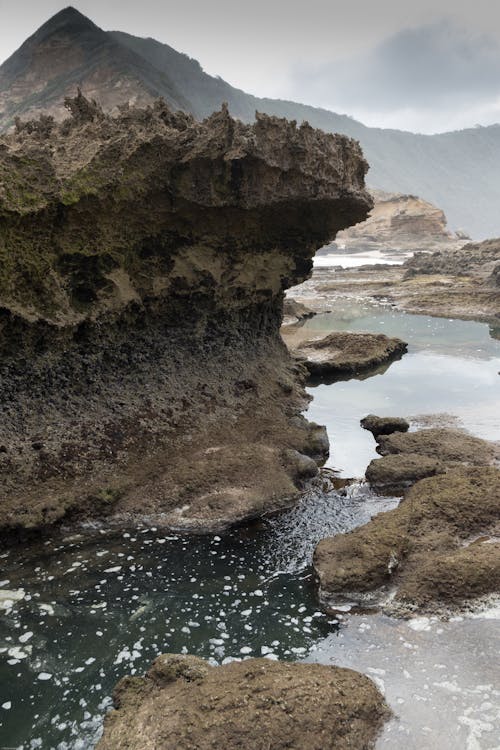 Brown Rock Formation Beside the Beach