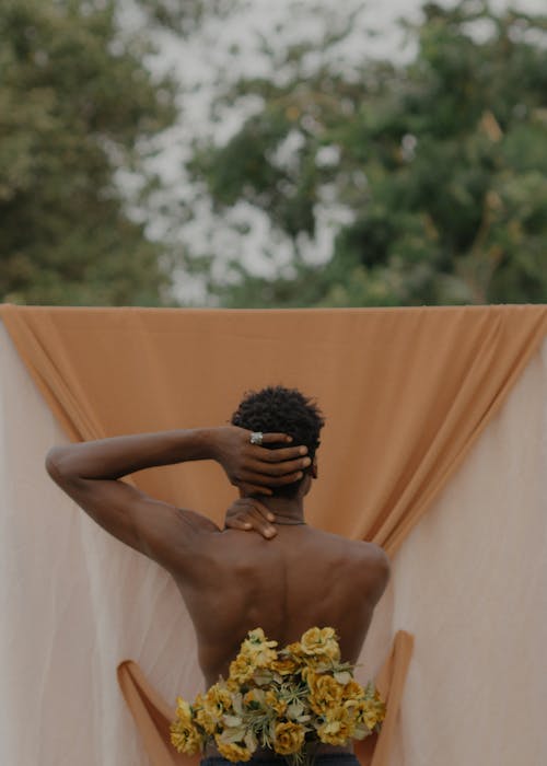 Naked Man Posing near Flower Composition Outdoors