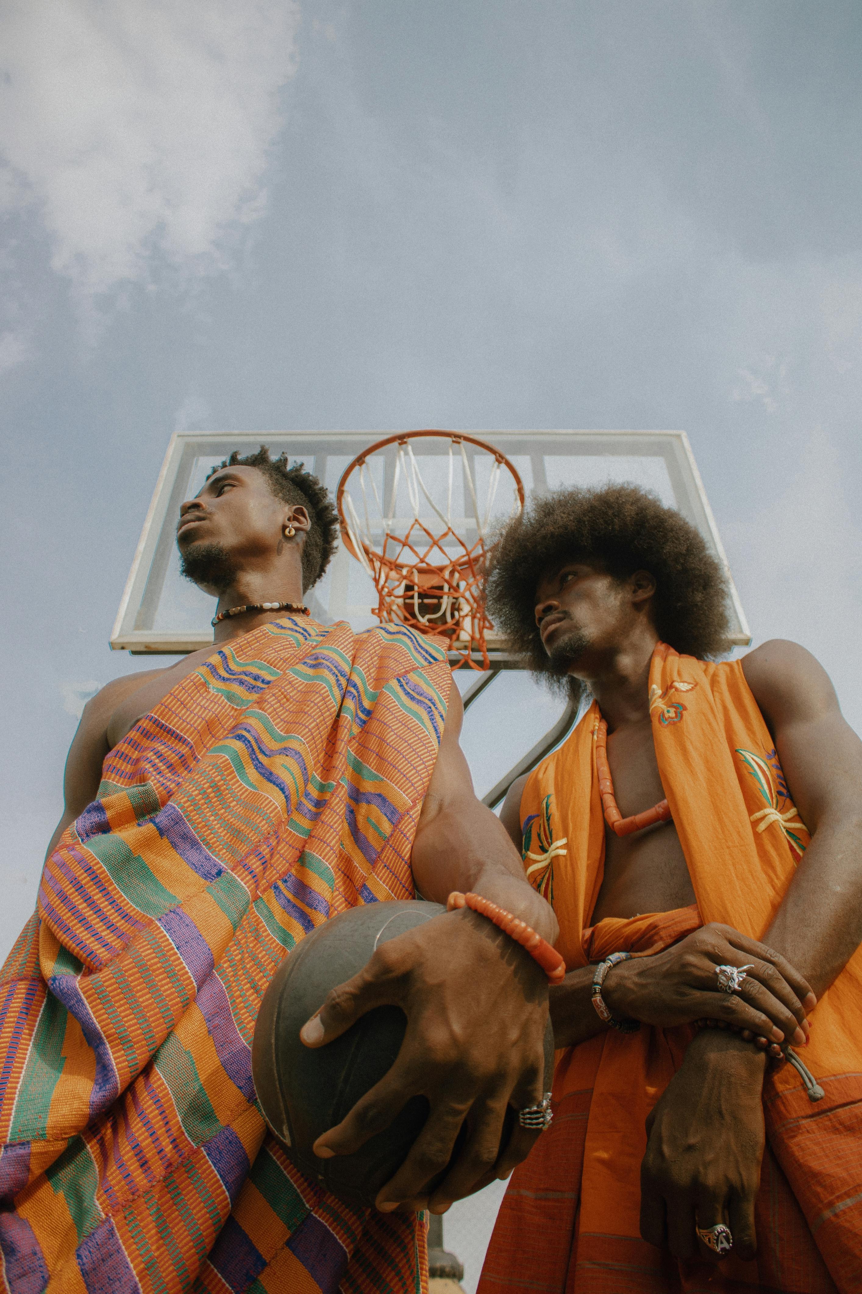 men in traditional clothing with basketball balls
