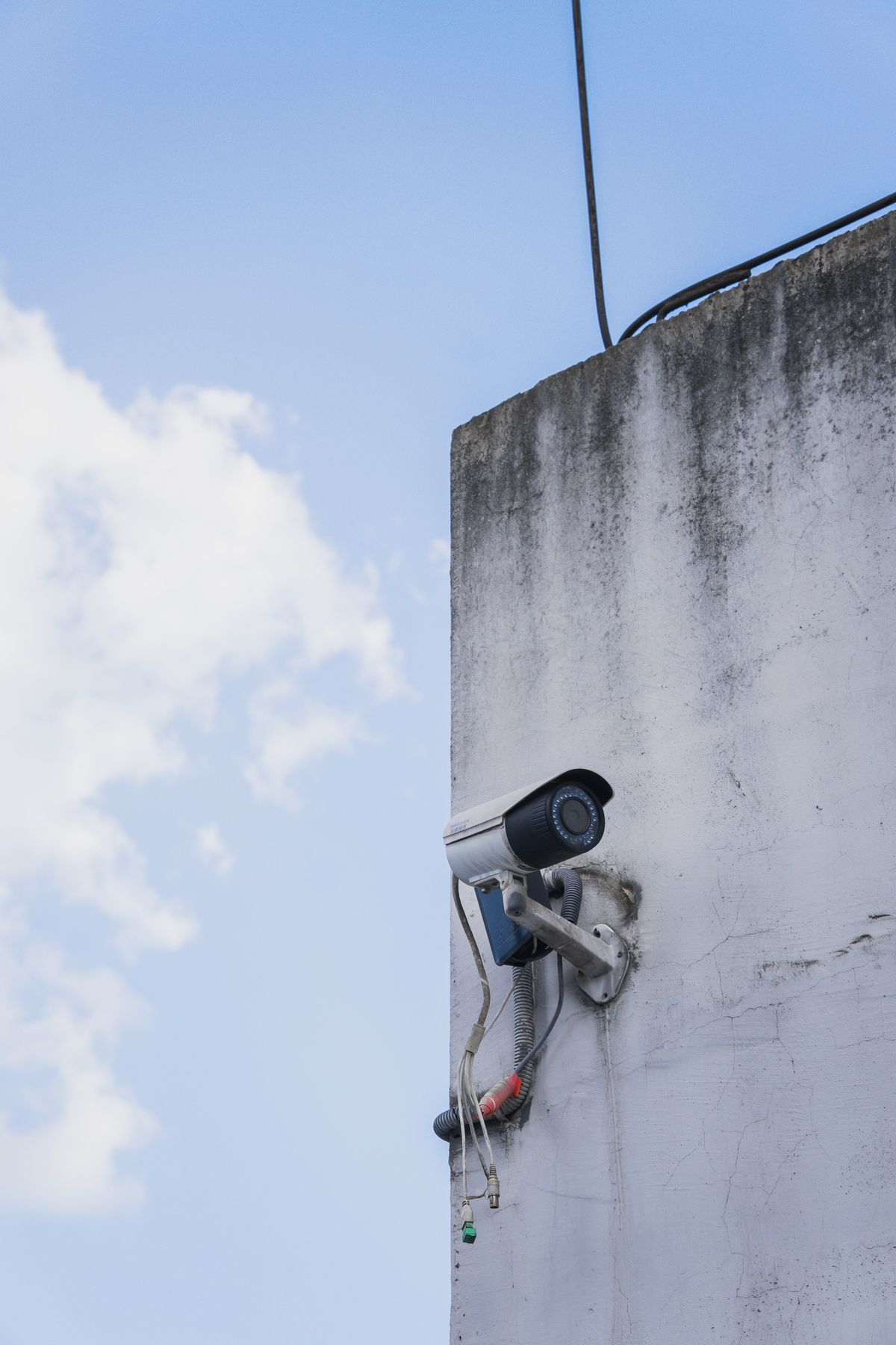 An outdoor video camera mounted against a blue sky