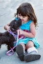 Black Dog Beside Little Girl