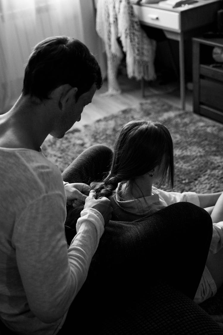 Man Braiding His Girlfriends Hair 