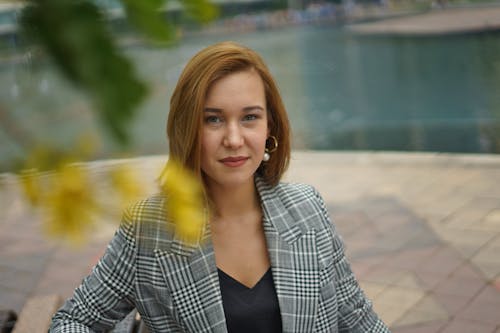 Close-Up Shot of a Woman in Plaid Blazer