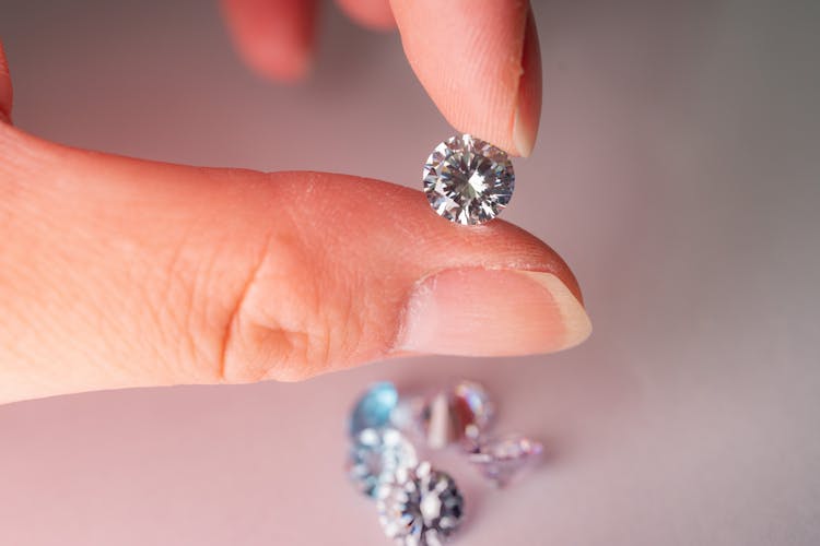 Close-Up Shot Of A Person Holding A Diamond